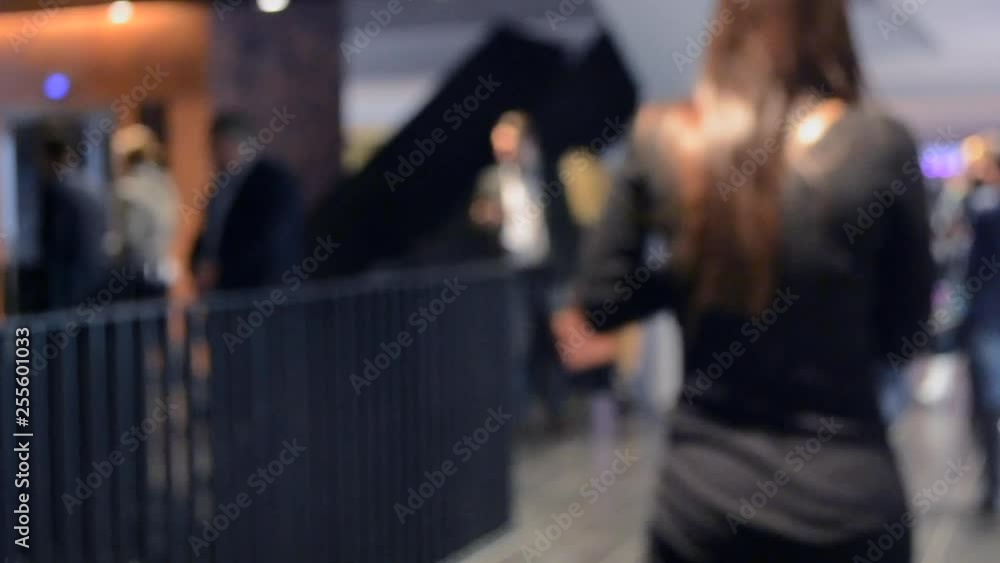 The crowd a lot of people walking down the corridor. Blurred Background. The crowd a lot of people walking down the corridor. Blurred Background.