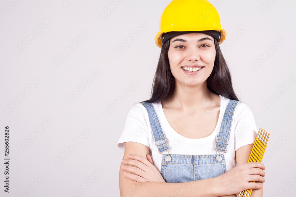 Proud serious young woman architect or engineer with arms crossed as professional building supervisor concept isolated on white background Proud serious young woman architect or engineer with arms crossed as professional building supervisor concept isolated on white background