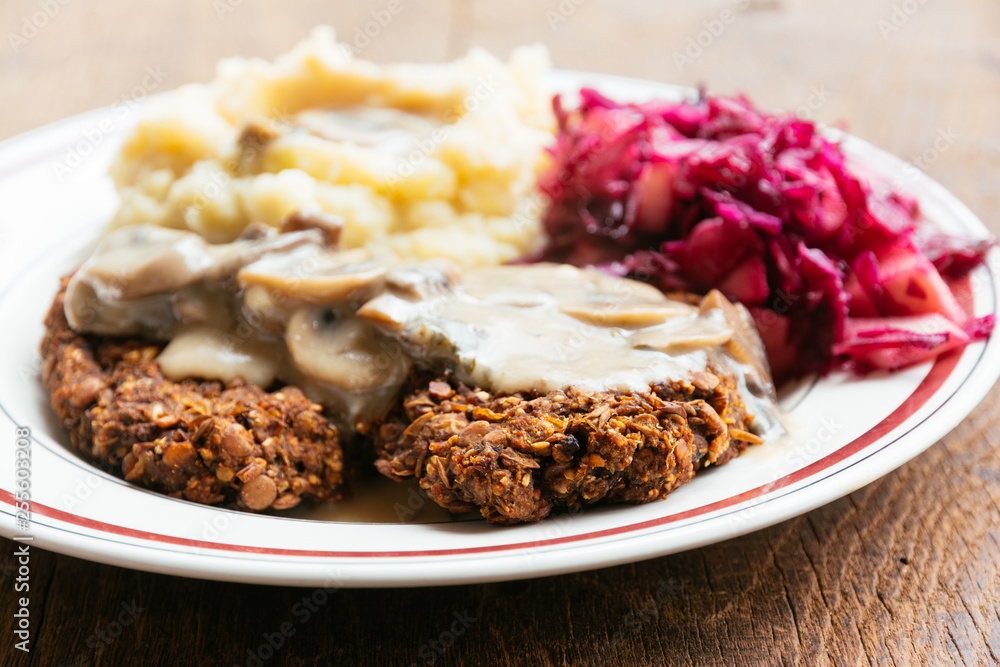Lentil-mushroom burgers with mashed potatoes and red cabbage