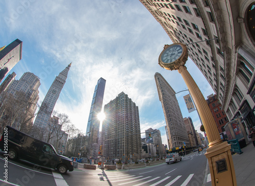 Cast iron street clock on fifth avenue, madison square. Wide angle shot with flatiron and skyline, New York, USA