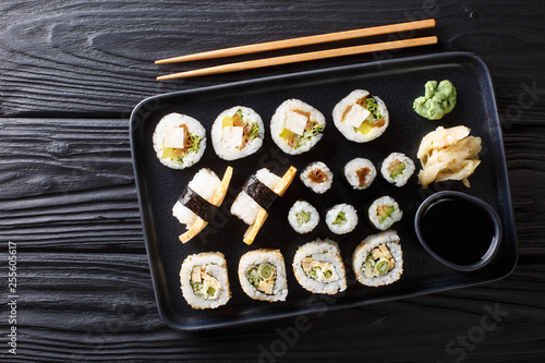 Japanese rolls set with tuna, tofu, eel, avocado, tamago closeup on a plate. Horizontal top view