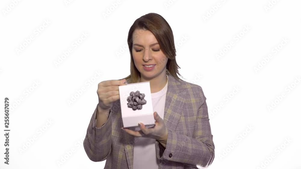 Young woman angry about bad gift isolated on white chromakey background Young woman angry about bad gift isolated on white chromakey background