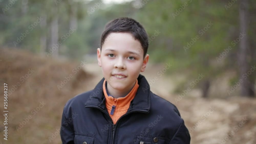 portrait of positive dancing kid in the forest, close up portrait of positive dancing kid in the forest, close up