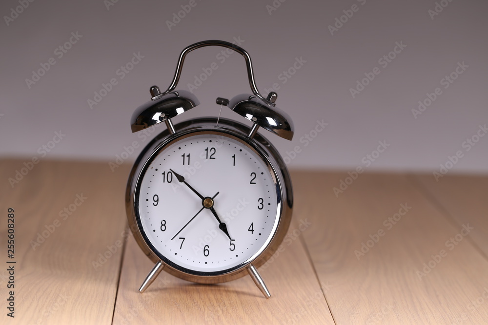 The old alarm clock on a light background The old alarm clock on a light background