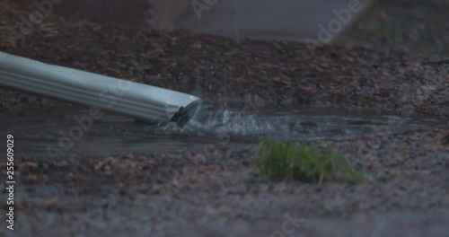 Water Flooding a Downspout During Rainfall