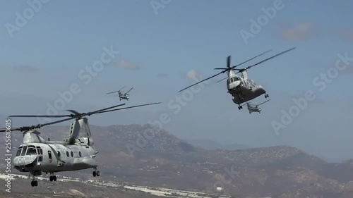 Marines flying double propeller helicopters.