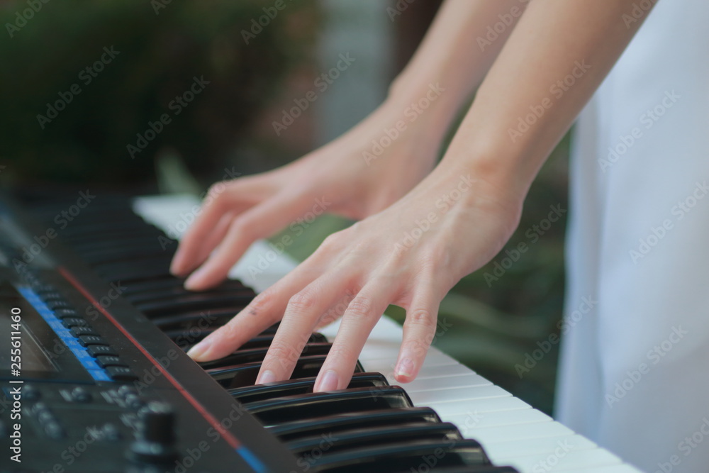Closeup of teenage girl hands playing music with electronic keyboard. Closeup of teenage girl hands playing music with electronic keyboard.