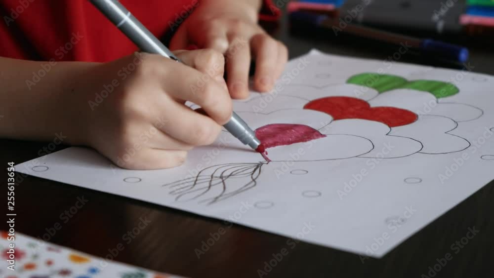 The child paints a picture marker The child paints a picture marker