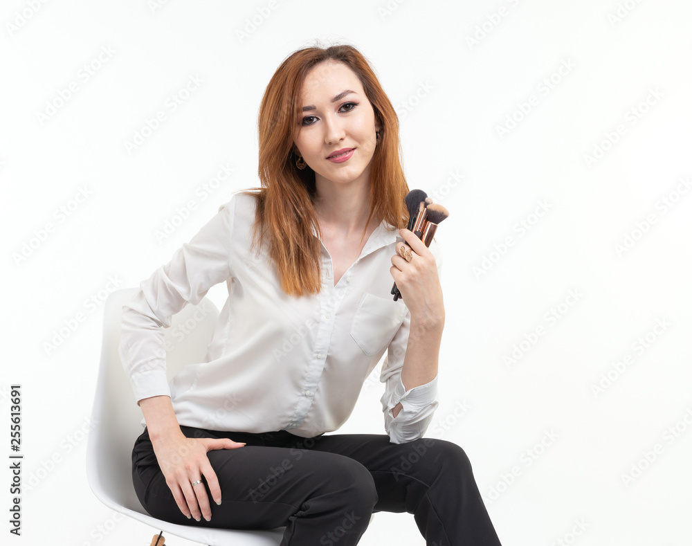 Makeup artist, beauty and cosmetics concept - Korean female make-up artist with makeup brushes on white background Makeup artist, beauty and cosmetics concept - Korean female make-up artist with makeup brushes on white background