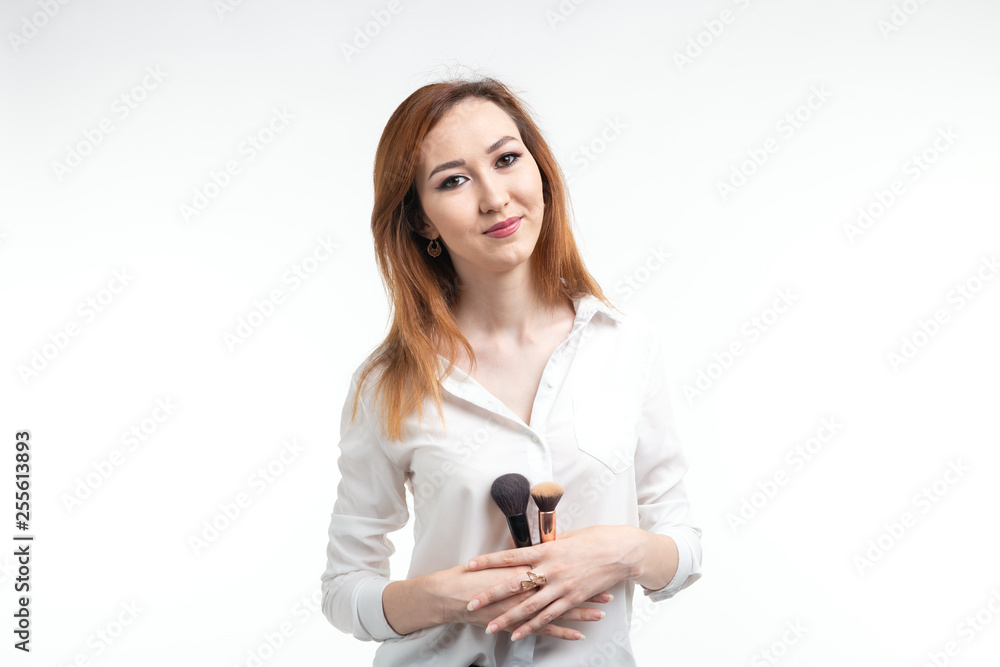 Beauty makeup artist. Close Up korean beautiful young woman pretty smiling holding make-up brushes on white background. Beauty makeup artist. Close Up korean beautiful young woman pretty smiling holding make-up brushes on white background.