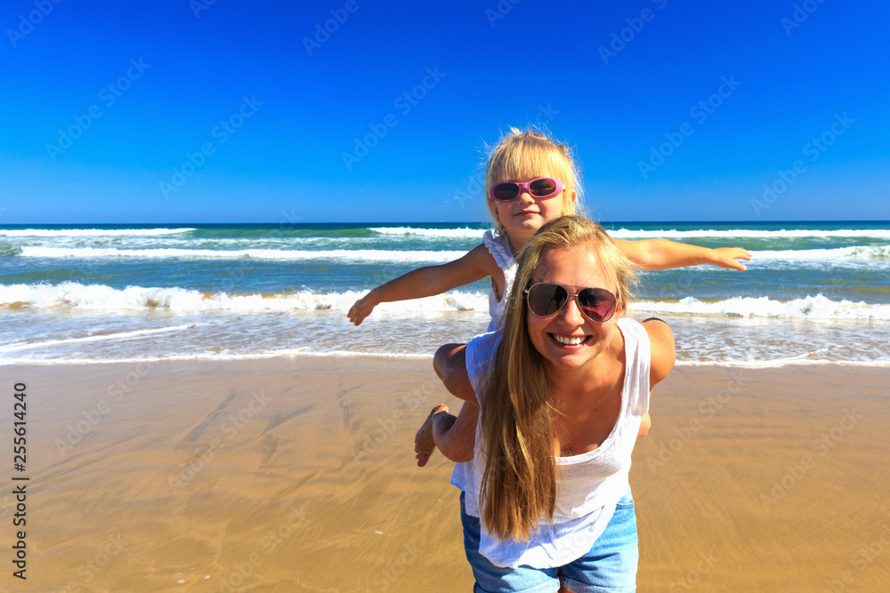 Happy mother and daughter spend their holidays on the seashore. Happy mother and daughter spend their holidays on the seashore.