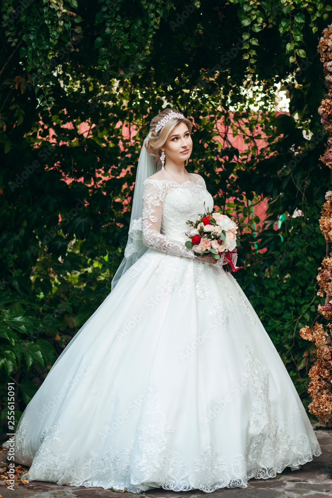 Portrait of a young beautiful bride with a bouquet Portrait of a young beautiful bride with a bouquet