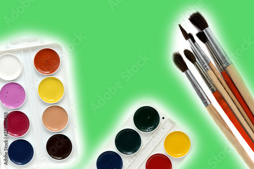 Watercolor paints and brushes isolated on white background close up