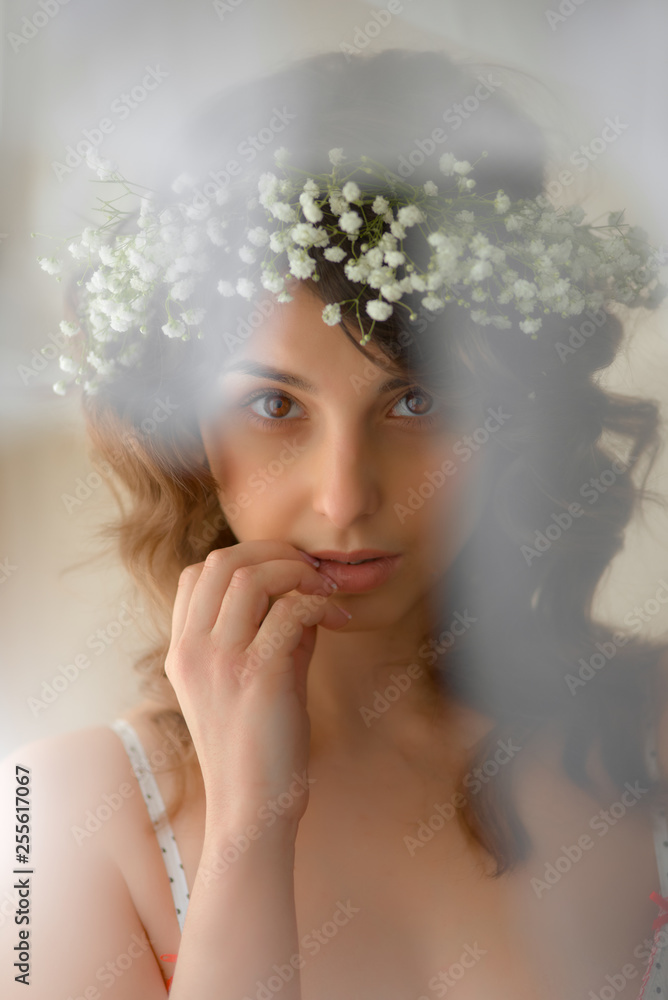 Portrait of thoughtful beautiful woman with flowers in her hair Portrait of thoughtful beautiful woman with flowers in her hair