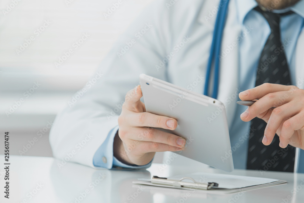 Close-up of doctor hand uses tablet Close-up of doctor hand uses tablet