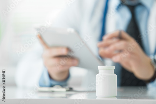 Close-up of tablet on background of doctor