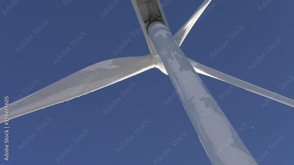 Wind turbine in winter with light snow flying from the blades Wind turbine in winter with light snow flying from the blades