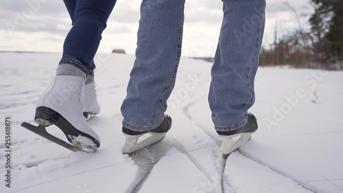 Couple ice skates on snowy lake photo