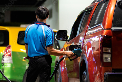 Hand refilling the fuel at the refuel station.