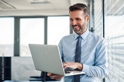 Businessman in modern office working on laptop