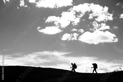 Two hikers walking along the mountain trail