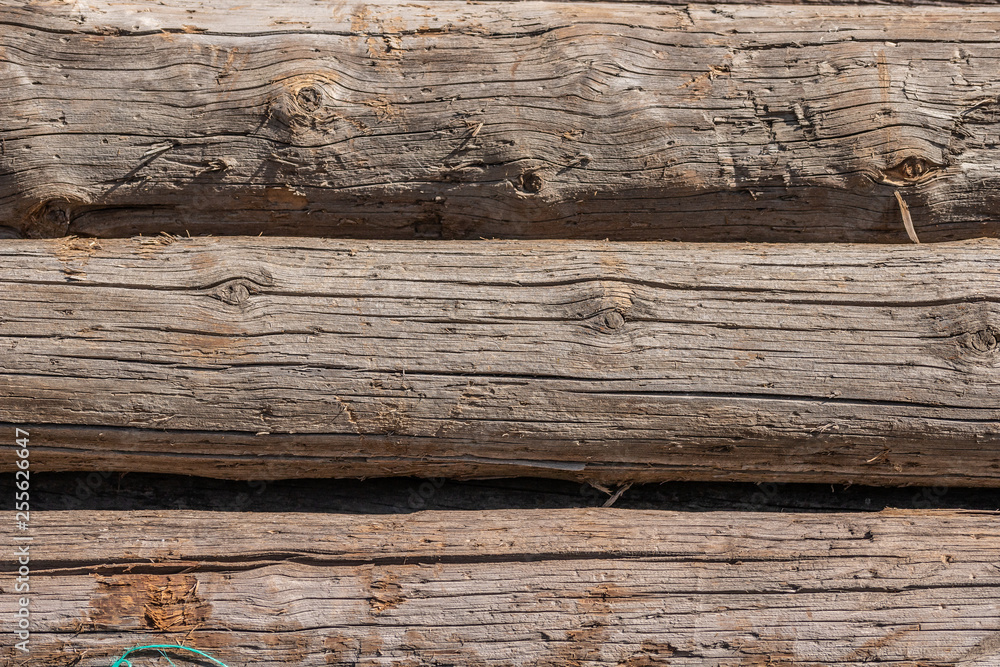 old wood gray round logs cracked weathered pattern old wood gray round logs cracked weathered pattern