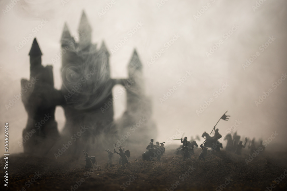 Obraz premium Medieval battle scene with cavalry and infantry. Silhouettes of figures as separate objects, fight between warriors on sunset foggy background.