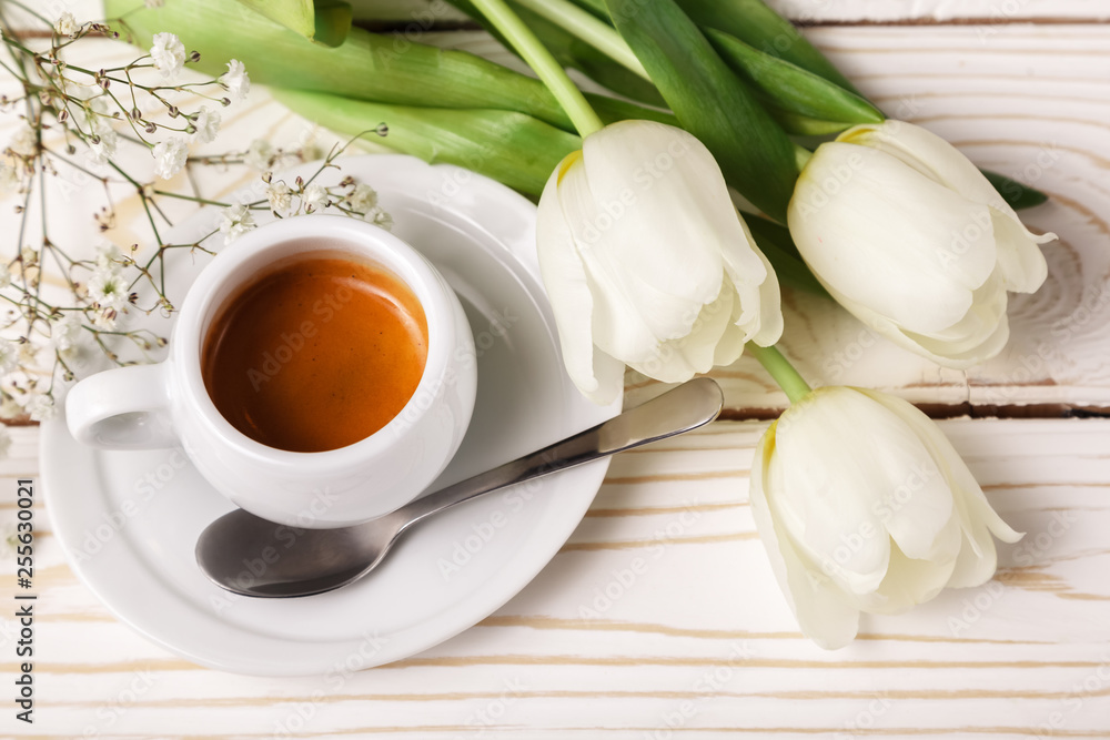 Spring tulips and coffee on a white wooden background, top view. Mother's day background, women's day, morning Birthday Spring tulips and coffee on a white wooden background, top view. Mother's day background, women's day, morning Birthday