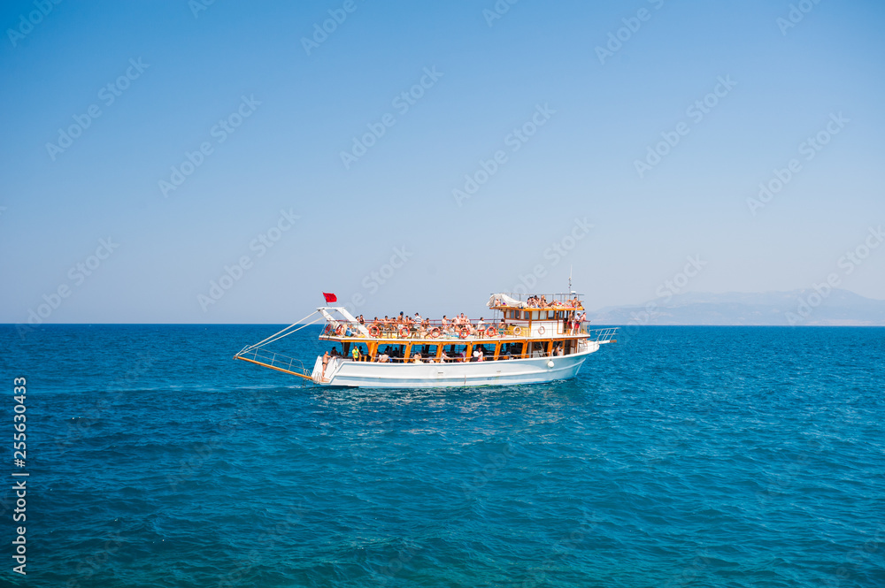 Obraz premium Yacht with tourists sailing on the sea, rest for all family, cruise on the islands