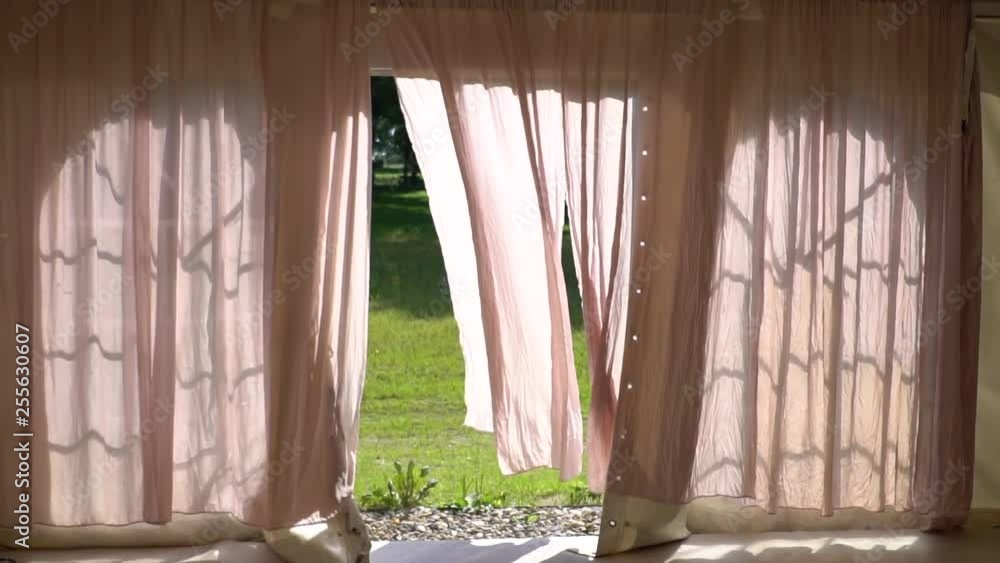 Curtains slowly blowing back from the wind. Curtains slowly blowing back from the wind.