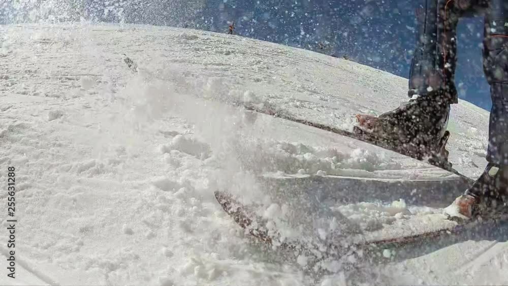 Slow motion, taking down snow from ski that goes direct to the camera Slow motion, taking down snow from ski that goes direct to the camera
