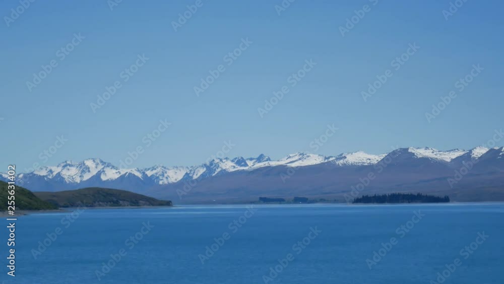 Panning view of Mount John from Lake Tekapo, New Zealand during blue bright sunny day. Panning view of Mount John from Lake Tekapo, New Zealand during blue bright sunny day.