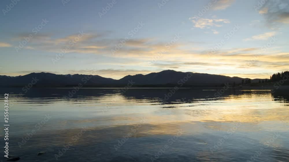 Timelapse Lake Tekapo sunsise over calm peaceful lake. Timelapse Lake Tekapo sunsise over calm peaceful lake.