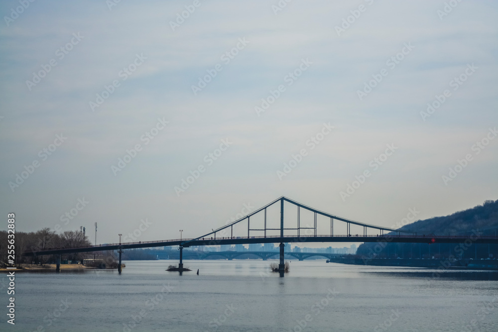 Beautiful view of the river and of Kiev, Ukraine. Sunny spring day. Bridges and city architecture. Landscape.