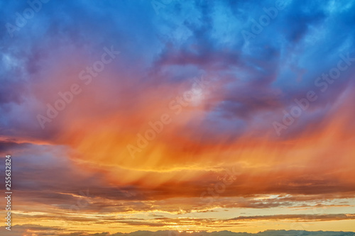 sunset sky background with natural color of beautiful cloud landscape and sun below horizon summer sunrise with sunlight transition from red to blue outdoor scene wide panorama view © vaalaa