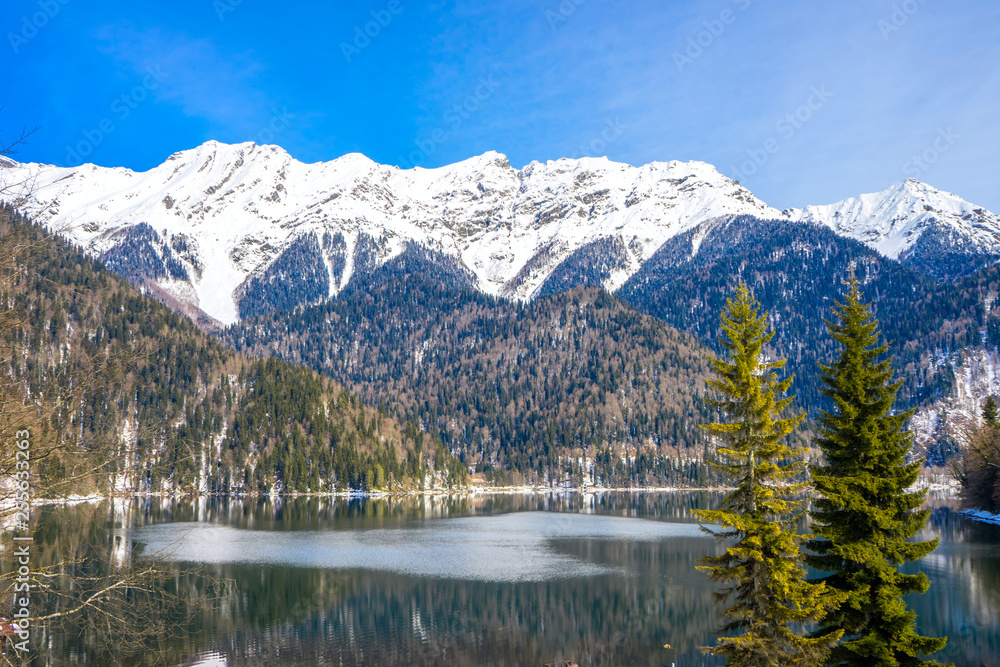 Mountains covered with snow on the shore of a beautiful lake