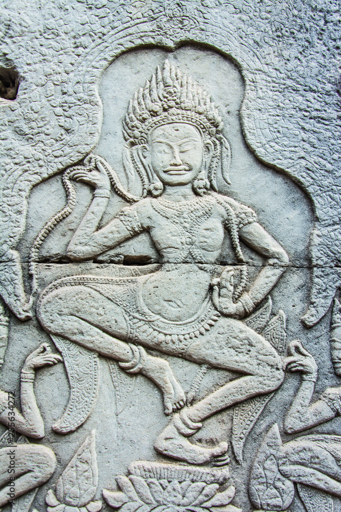 Sculptures of ancient  khmer  carve  the wall into a dancing  angel.
