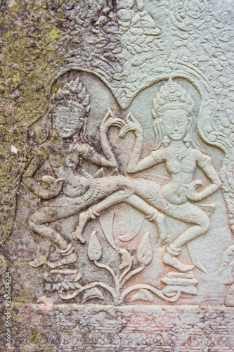 Sculptures of ancient khmer carve the wall into a dancing angel.