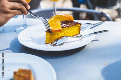 Person eating orange cake photo