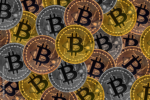 Many bronze, silver and gold coins with Bitcoin sign, It is a cryptocurrency background.