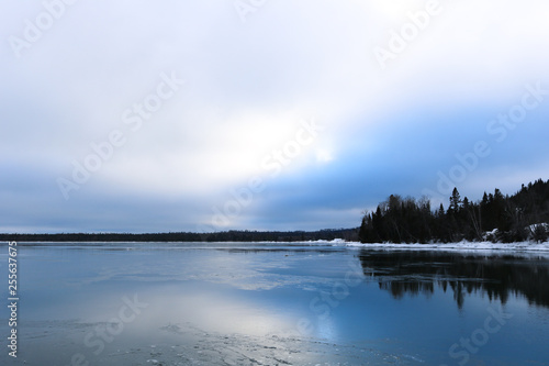 Winter landscape with ice lake and snow