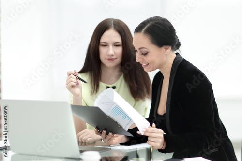 close up. business woman making notes sitting on her Desk