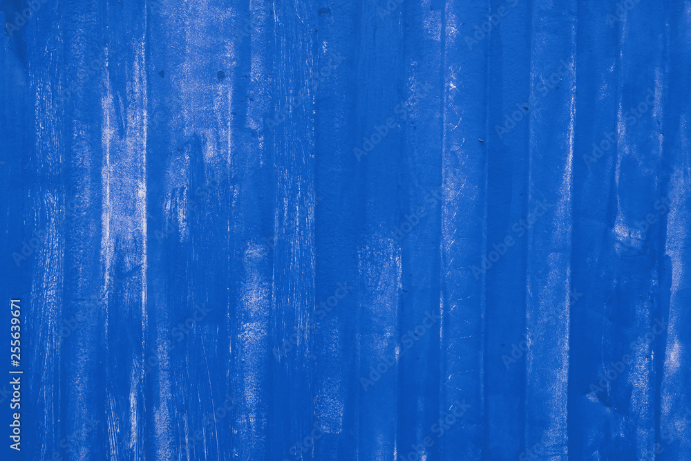 Fototapeta premium Blue painted uneven metal wall surface close up
