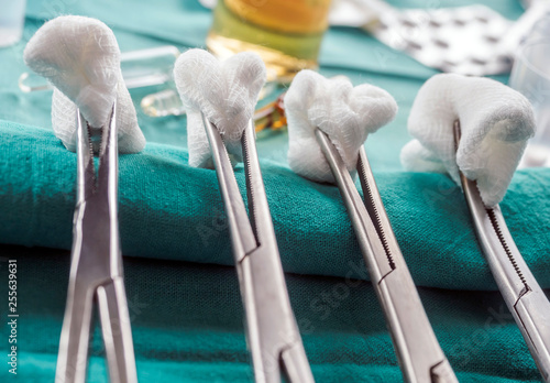 Scissors surgical with torundas in an operating theater, composition horizontal, conceptual image photo