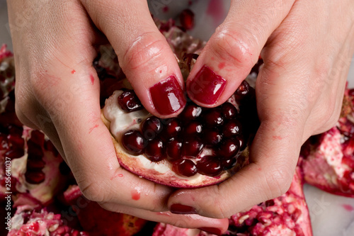 woman hands opening a pomagranate