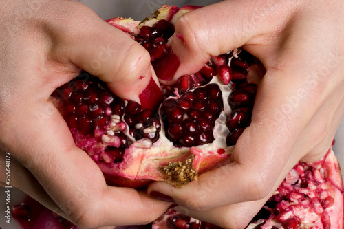 woman hands opening a pomagranate