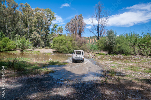 Rural Andalucia, Andalusia. Spain. 4WD vehicle crossing river. Back view. © Jakub Rutkiewicz