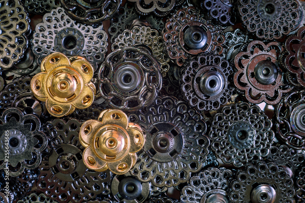 metal decorative buttons of dark metal and two golden buttons. opposition concept. metal decorative buttons of dark metal and two golden buttons. opposition concept.