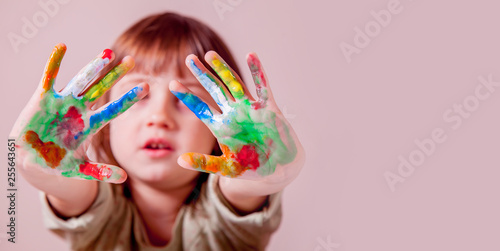 Colorful painted hands of cutel little child girl.