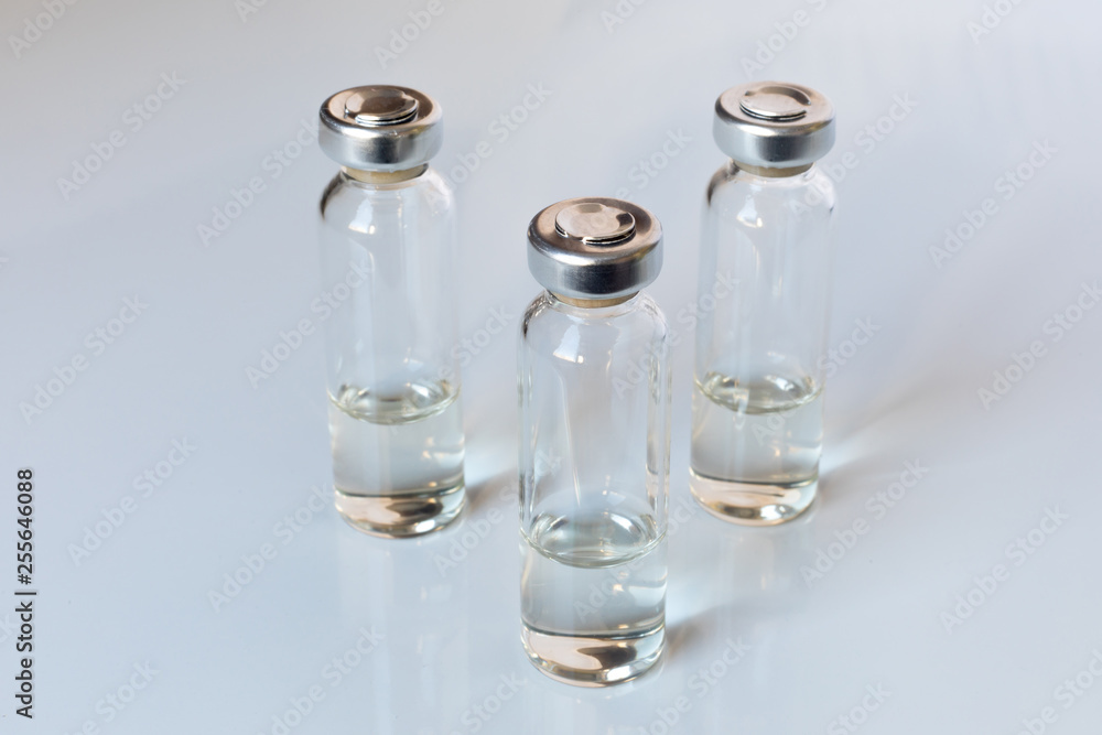 Medical glass vials and syringe for vaccination. Medical concept Medical glass vials and syringe for vaccination. Medical concept